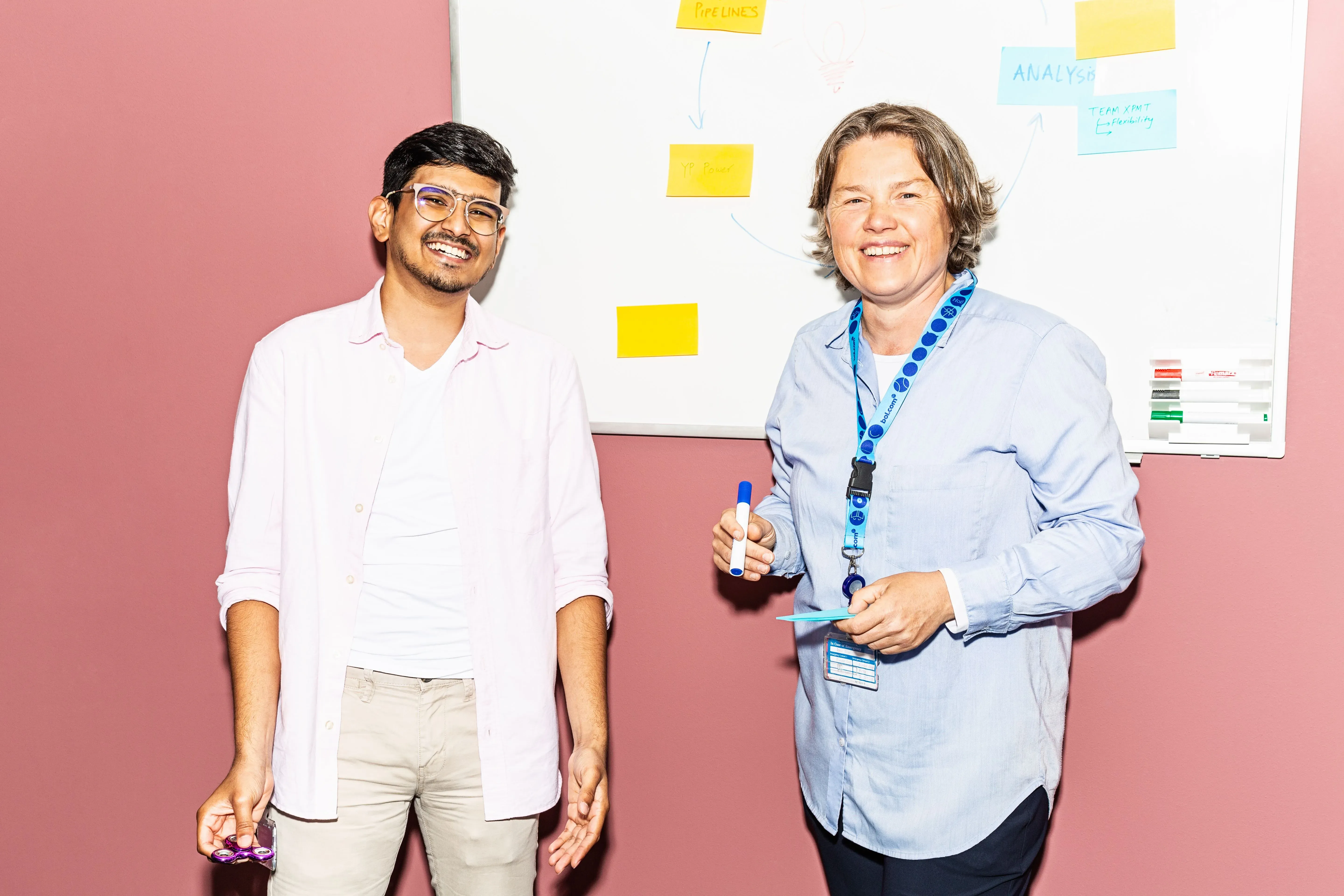 Tech colleagues standing in front of a whiteboard 